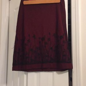 Red skirt with black lace embroidered overlay